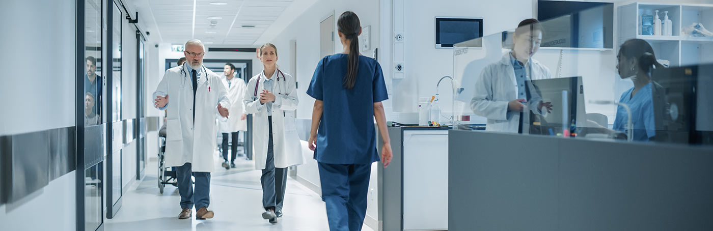 Two doctors walking down the hallway of a hospital